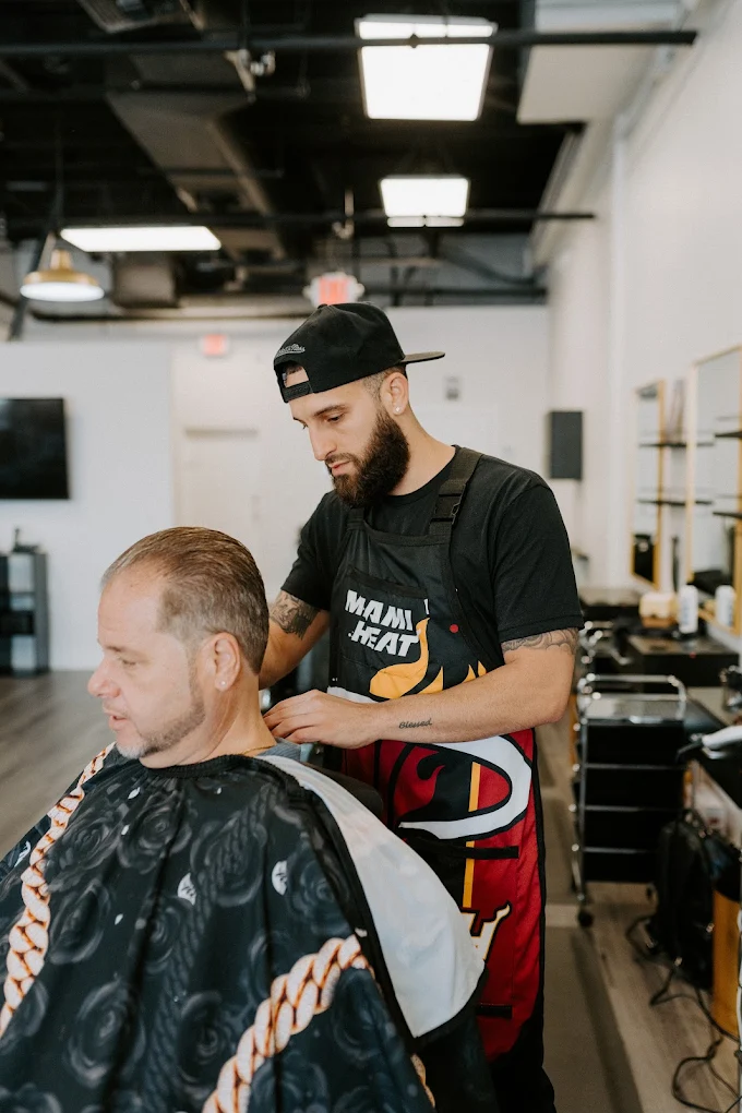 Anthony 'Cap' Capra, owner of Victory Barbershop, cutting hair in Boca Raton