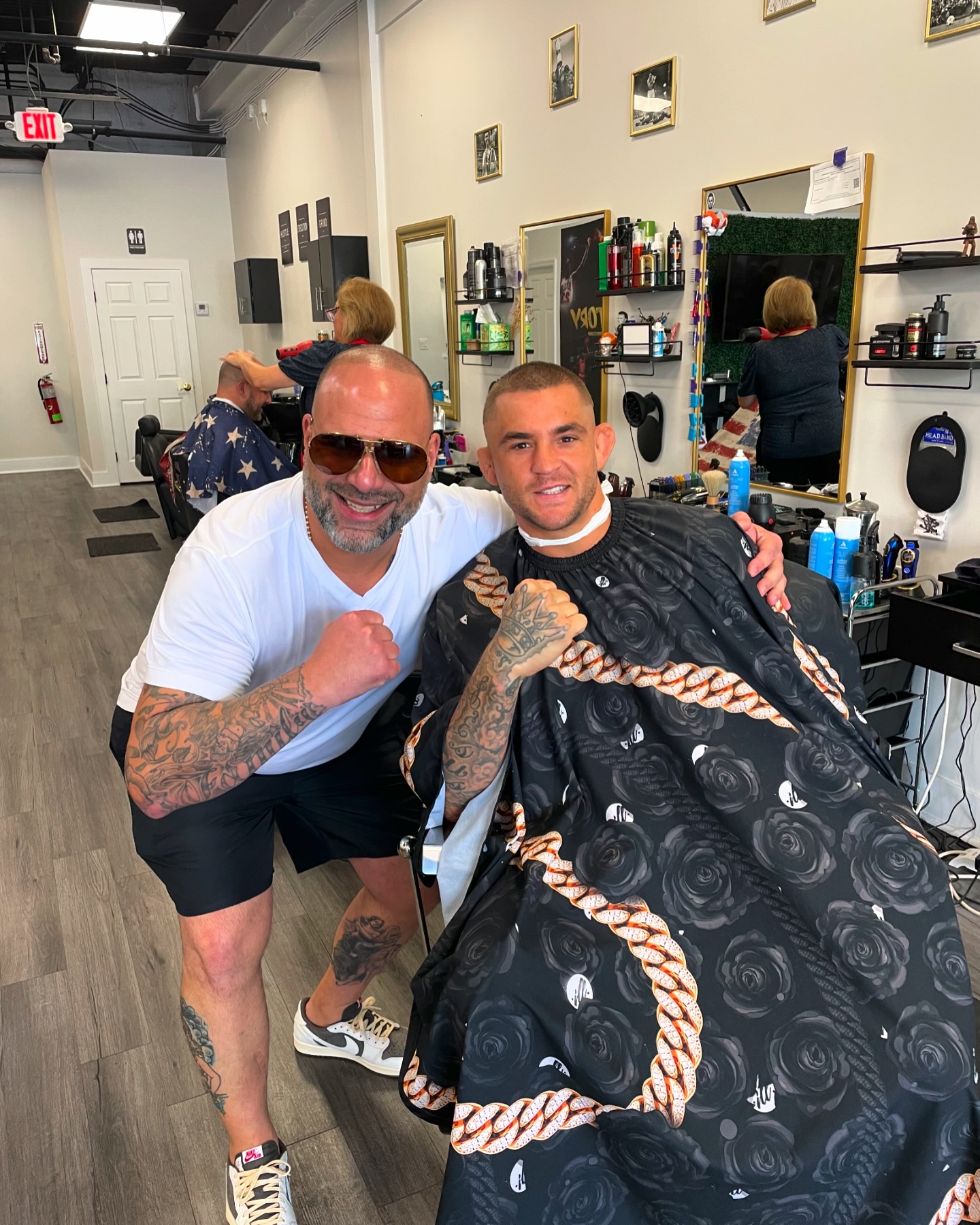 Anthony 'Cap' Capra standing with UFC Fighter Dustin Poirier at Victory Barbershop